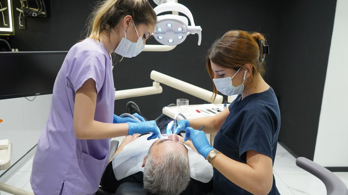 Dentists working on a patient in a modern Istanbul clinic, showcasing professional dental care.